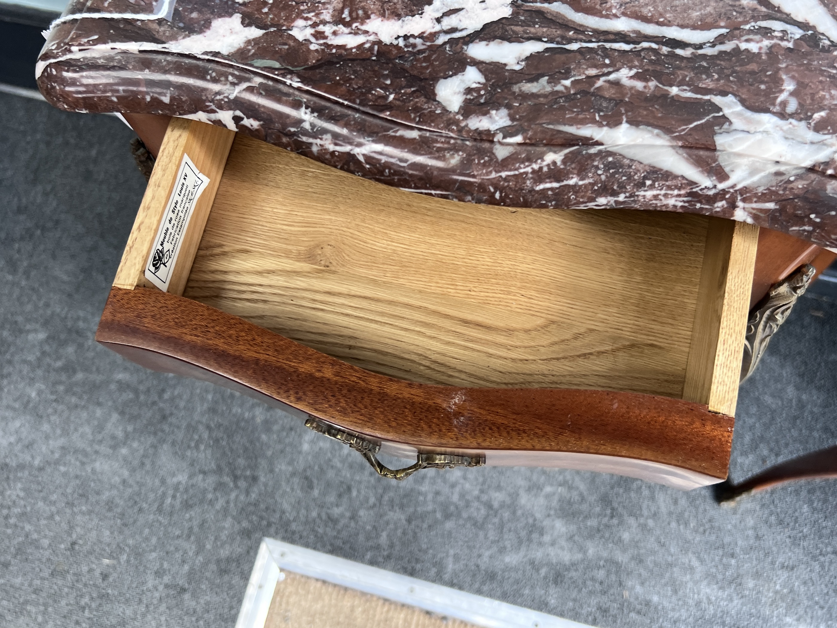 A pair of French Louis XV style marquetry inlaid serpentine rouge marble topped bedside cabinets, width 40cm, height 72cm